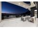 Stylish covered patio seating with a panoramic view of the glittering Las Vegas cityscape at 667 Solitude Rock Ct, Henderson, NV 89012