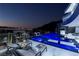 Backyard featuring a modern pool, jacuzzi, lounge chairs, and city views at 667 Solitude Rock Ct, Henderson, NV 89012