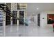 Hallway featuring a staircase, art, and wall of temperature controlled wine storage at 667 Solitude Rock Ct, Henderson, NV 89012