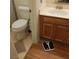 Standard bathroom with a wood cabinet sink, toilet and adjacent scale on the floor at 6903 Wineberry Dr, Las Vegas, NV 89119