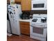 Galley kitchen featuring white appliances and wood-look flooring at 6903 Wineberry Dr, Las Vegas, NV 89119