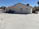 Spacious backyard featuring a concrete patio, house and partial fence in the distance at 7133 Tropical Island Cir, Las Vegas, NV 89129