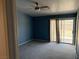 Spacious bedroom featuring a ceiling fan and sliding glass doors to the backyard at 7133 Tropical Island Cir, Las Vegas, NV 89129