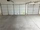 Spacious garage with concrete flooring and two white garage doors at 7133 Tropical Island Cir, Las Vegas, NV 89129