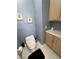 Powder room with a modern toilet and custom wood cabinets at 720 Florida St, Pahrump, NV 89048