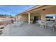 Spacious covered patio area with tables and seating for entertaining guests or relaxing at 720 Florida St, Pahrump, NV 89048