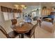 Inviting dining area featuring a round wood table and view into the spacious living room at 720 Florida St, Pahrump, NV 89048