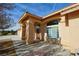 Home featuring an arched entryway with pillars and a sitting area, blending classic design with comfort at 720 Florida St, Pahrump, NV 89048