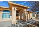 Inviting home showcasing an arched front entrance with decorative pillars and a cozy seating area at 720 Florida St, Pahrump, NV 89048