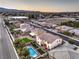 An aerial view showcases a home with a backyard oasis, including a pool, manicured lawn, and desert surroundings at 7411 Zonal Ave, Las Vegas, NV 89131