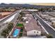 Aerial view of a residential area with a backyard pool, artificial turf, and mountain views in the distance at 7411 Zonal Ave, Las Vegas, NV 89131