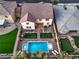 An aerial shot showcases a backyard with a pool, manicured lawn, lounge chairs and outdoor lighting at 7411 Zonal Ave, Las Vegas, NV 89131