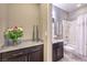 Well-lit bathroom featuring a granite countertop vanity and a shower-tub combination with a curtain at 7411 Zonal Ave, Las Vegas, NV 89131