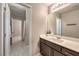 Stylish bathroom features modern vanity, large mirror, and tiled flooring at 7411 Zonal Ave, Las Vegas, NV 89131