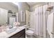 Well-lit bathroom with vanity and shower-tub combination, complete with modern fixtures and storage at 7411 Zonal Ave, Las Vegas, NV 89131