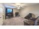 Carpeted bedroom featuring ceiling fan, office and sitting areas, and neutral colors at 7411 Zonal Ave, Las Vegas, NV 89131