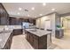 Bright kitchen boasts stainless steel appliances, granite countertops, and a center island with bar seating at 7411 Zonal Ave, Las Vegas, NV 89131