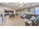 Open-concept living room featuring tile floors, a ceiling fan, and stylish furniture, flowing into the kitchen and dining area at 7411 Zonal Ave, Las Vegas, NV 89131