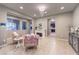 Bright living room featuring large windows, tile flooring, fireplace, and an elegant chandelier at 7411 Zonal Ave, Las Vegas, NV 89131