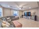 Bright and airy living room with tile floors, a sectional sofa, and a large flat-screen TV at 7411 Zonal Ave, Las Vegas, NV 89131