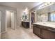 Main bathroom featuring double sinks, a glass-enclosed shower, and a separate door to the toilet room at 7411 Zonal Ave, Las Vegas, NV 89131