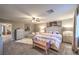 Spacious main bedroom boasts neutral walls, ceiling fan, decorative accents, and an inviting upholstered bed at 7411 Zonal Ave, Las Vegas, NV 89131