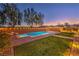 Inviting backyard pool with lounge chairs, manicured lawn, and charming string lights creating a relaxing outdoor oasis at 7411 Zonal Ave, Las Vegas, NV 89131