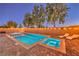 Backyard pool and hot tub with a brick-paved patio, lounge chairs, and inviting underwater lighting for evening enjoyment at 7411 Zonal Ave, Las Vegas, NV 89131