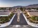 A neighborhood street view featuring tree-lined streets and mountain views at 7411 Zonal Ave, Las Vegas, NV 89131