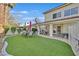 An outdoor living area that features a patio, dining furniture and artificial grass at 7520 Cobal Canyon Ln, Las Vegas, NV 89129