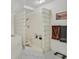 Bright bathroom featuring a glass block shower enclosure, soaking tub, and tile flooring at 7520 Cobal Canyon Ln, Las Vegas, NV 89129