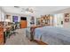 Spacious bedroom featuring a ceiling fan, a large dresser, a desk, and a bed at 7520 Cobal Canyon Ln, Las Vegas, NV 89129