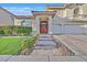 Inviting home entrance showcasing a well-kept lawn and a stone pathway leading to the front door at 7520 Cobal Canyon Ln, Las Vegas, NV 89129