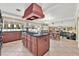 Open-concept kitchen featuring a large island, updated appliances, and tile flooring at 7520 Cobal Canyon Ln, Las Vegas, NV 89129