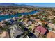 Aerial view of a lakefront community with houses nestled along the serene waters at 7624 Desert Delta Dr, Las Vegas, NV 89128