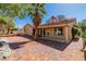 Inviting backyard with a brick patio, lush trees, and a neutral exterior, perfect for outdoor living at 7624 Desert Delta Dr, Las Vegas, NV 89128