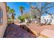 The backyard has mature trees, brick pavers, stone accents, and providing a serene outdoor living space at 7624 Desert Delta Dr, Las Vegas, NV 89128