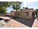 A delightful backyard shows brick pavers, a palm tree, and the home's exterior at 7624 Desert Delta Dr, Las Vegas, NV 89128