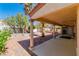 Expansive backyard featuring a covered patio, brick pavers, and lush landscaping, ideal for outdoor entertaining at 7624 Desert Delta Dr, Las Vegas, NV 89128