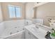 Bathroom showcasing soaking tub and vanity with sink and mirror at 7624 Desert Delta Dr, Las Vegas, NV 89128