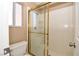 Bright bathroom with a tile shower, gold frame, and clear glass door at 7624 Desert Delta Dr, Las Vegas, NV 89128