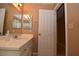 Bathroom vanity featuring double sinks, chrome fixtures, and white countertops at 7624 Desert Delta Dr, Las Vegas, NV 89128