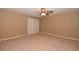 Bedroom with a ceiling fan, plush carpet, and sliding glass doors at 7624 Desert Delta Dr, Las Vegas, NV 89128