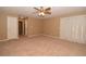 Spacious bedroom with fan, carpet, and sliding glass doors at 7624 Desert Delta Dr, Las Vegas, NV 89128