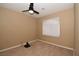 Neutral bedroom featuring a window with blinds, ceiling fan, and plush carpeting at 7624 Desert Delta Dr, Las Vegas, NV 89128