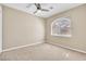 This bedroom provides a cozy atmosphere with soft carpeting and ample natural light from a sunny window at 7624 Desert Delta Dr, Las Vegas, NV 89128