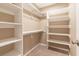 Walk-in closet with carpet and custom shelving at 7624 Desert Delta Dr, Las Vegas, NV 89128