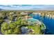 Aerial view of a community pool and recreation center with palm trees and waterfront views at 7624 Desert Delta Dr, Las Vegas, NV 89128