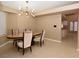 Cozy dining area with tile flooring and an elegant light fixture at 7624 Desert Delta Dr, Las Vegas, NV 89128