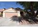 Exterior home elevation highlighting well-maintained lawn and two car garage at 7624 Desert Delta Dr, Las Vegas, NV 89128